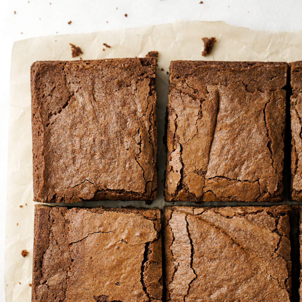 Sliced Black Magic Homemade Brownies on parchment paper