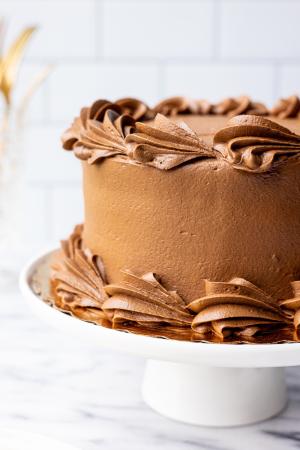 chocolate cake on a white cake stand