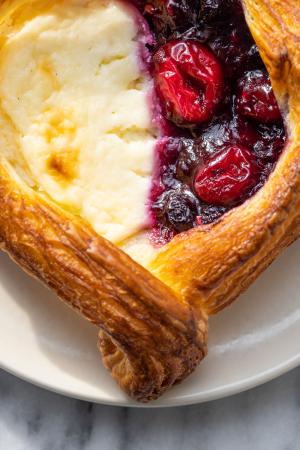 a close-up of a fruit and cheese danish