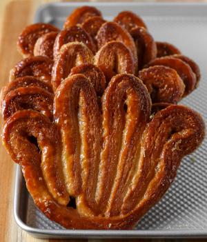 a stack of palmiers on a sheet tray