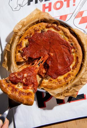 chicago deep dish style pizza; one slice is being removed
