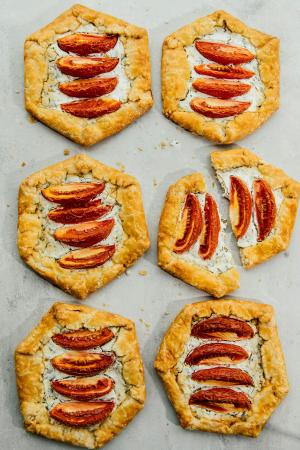 6 individual-sized goat cheese and tomato galettes; one is sliced in half